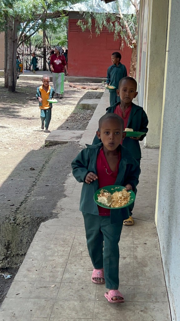 ACTS sponsored children carrying school meals